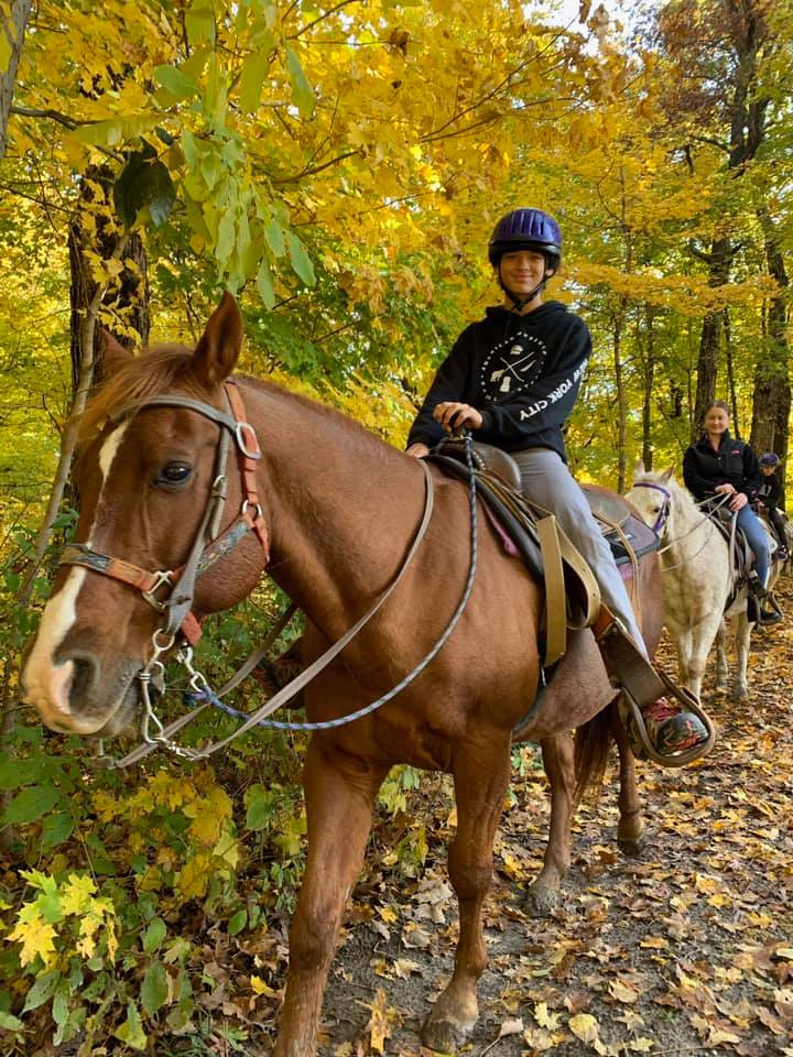 Group horseback riding at Cedar Creek Ranch